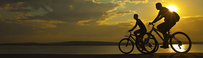 Two bicyclers in the sunset